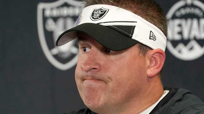 Raiders head coach Josh McDaniels grimaces at a press conference